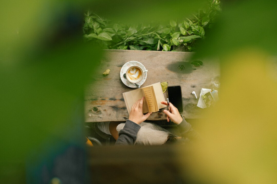 writer taking notes in cafe
